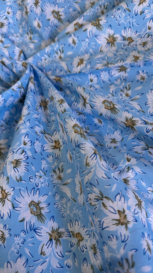 Floral fabric with white flowers on a blue background
