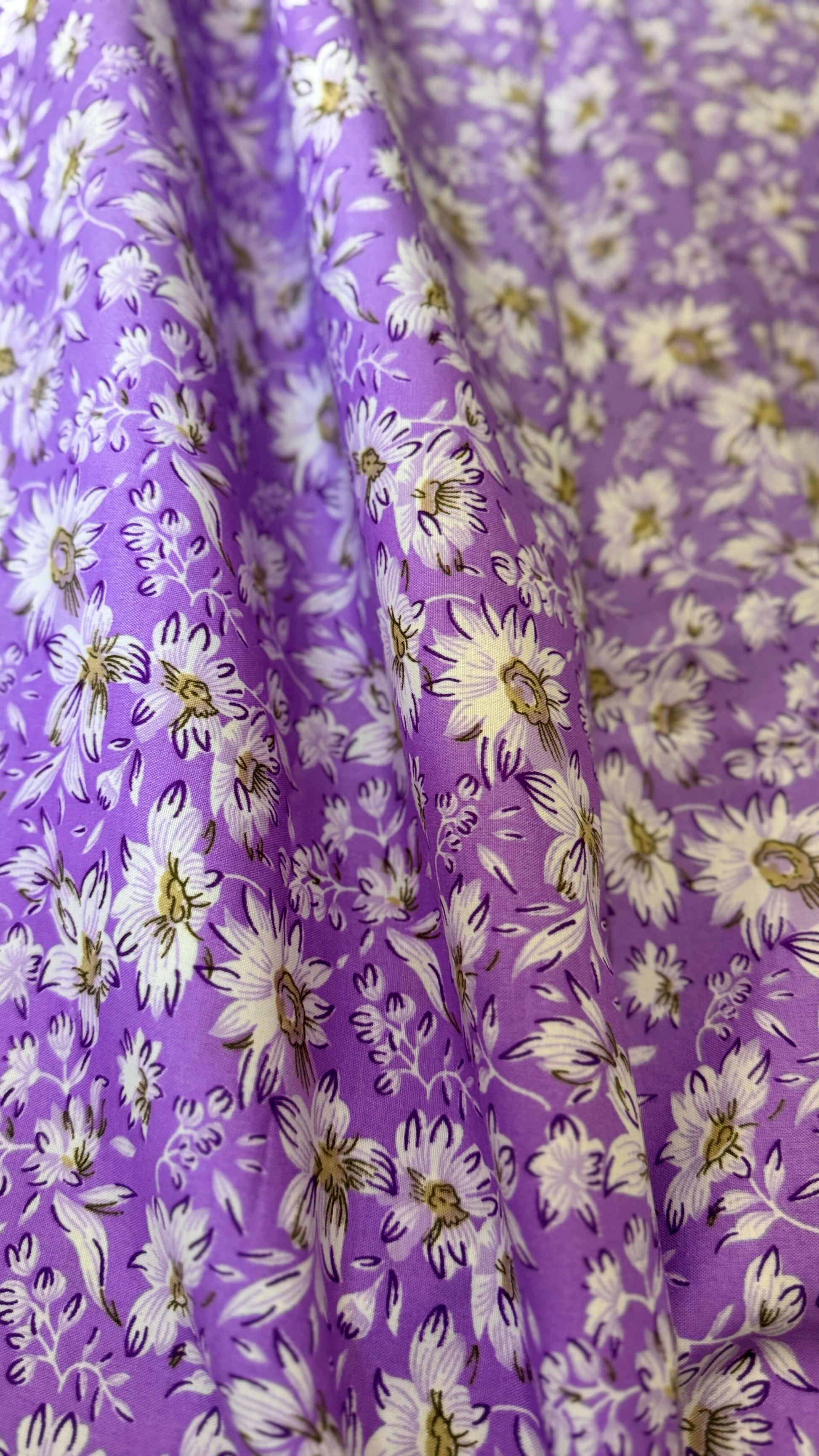 Floral fabric with white flowers on a purple background
