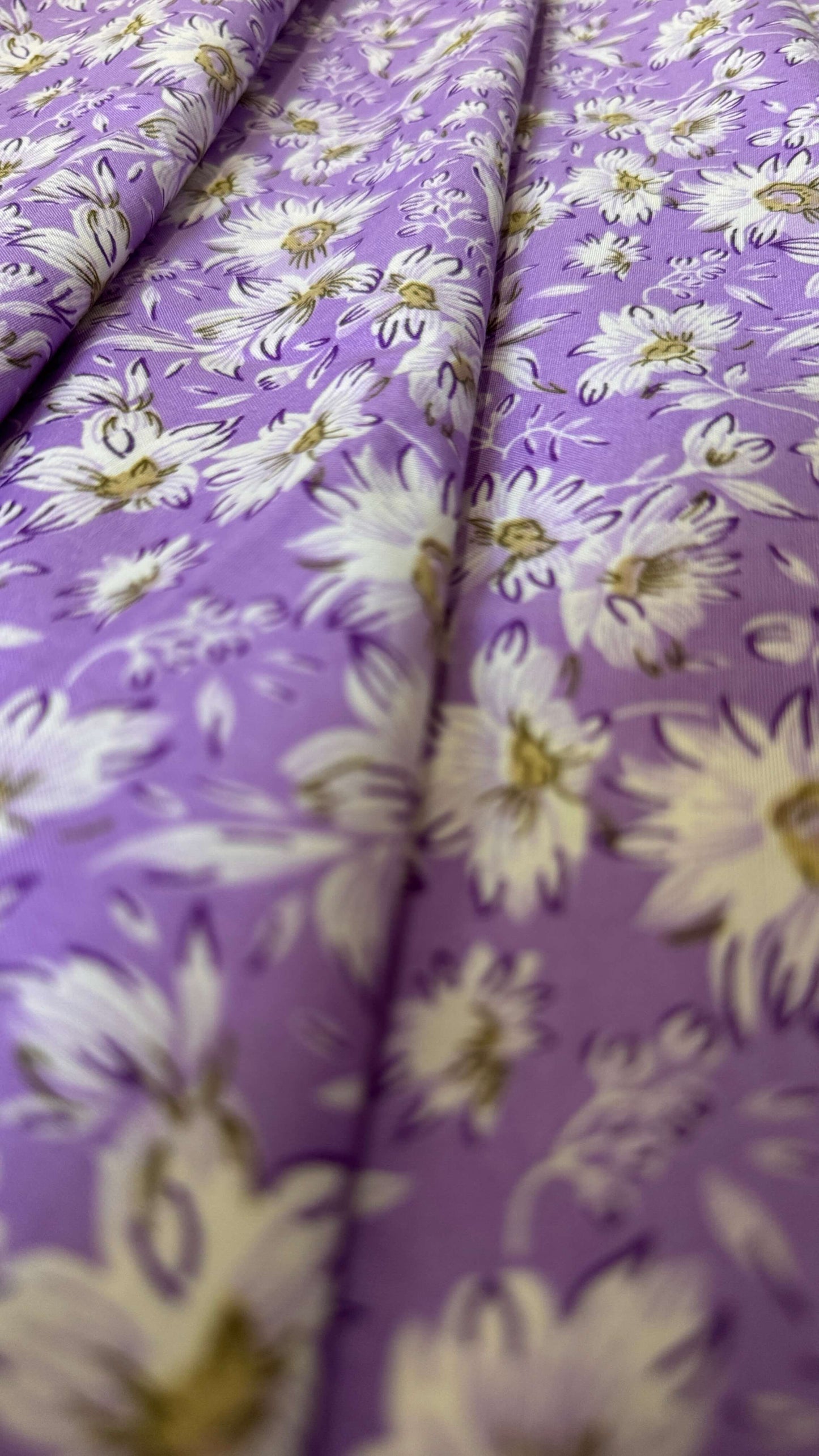 Floral fabric with white flowers on a purple background