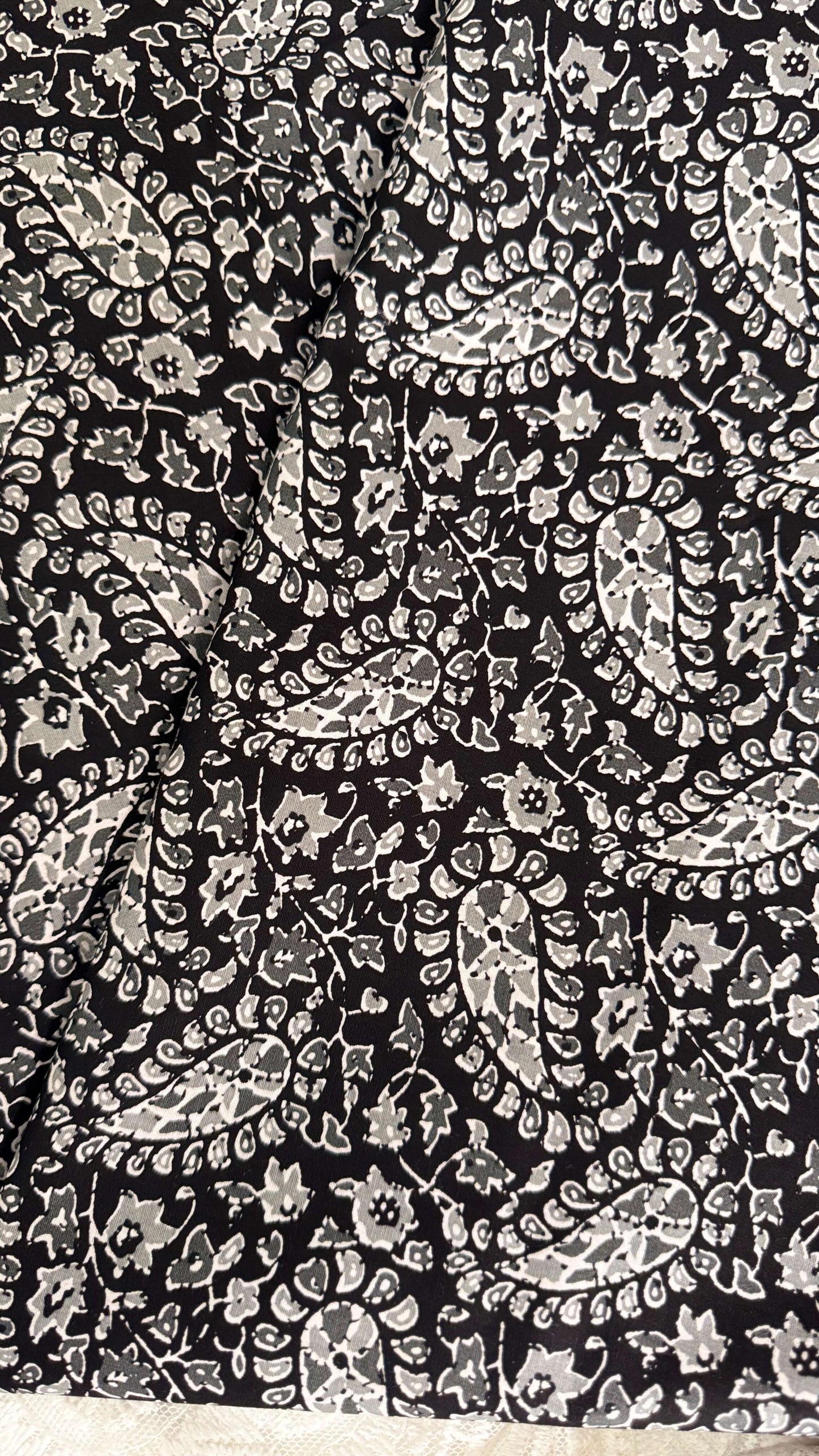 Black fabric with white paisley pattern