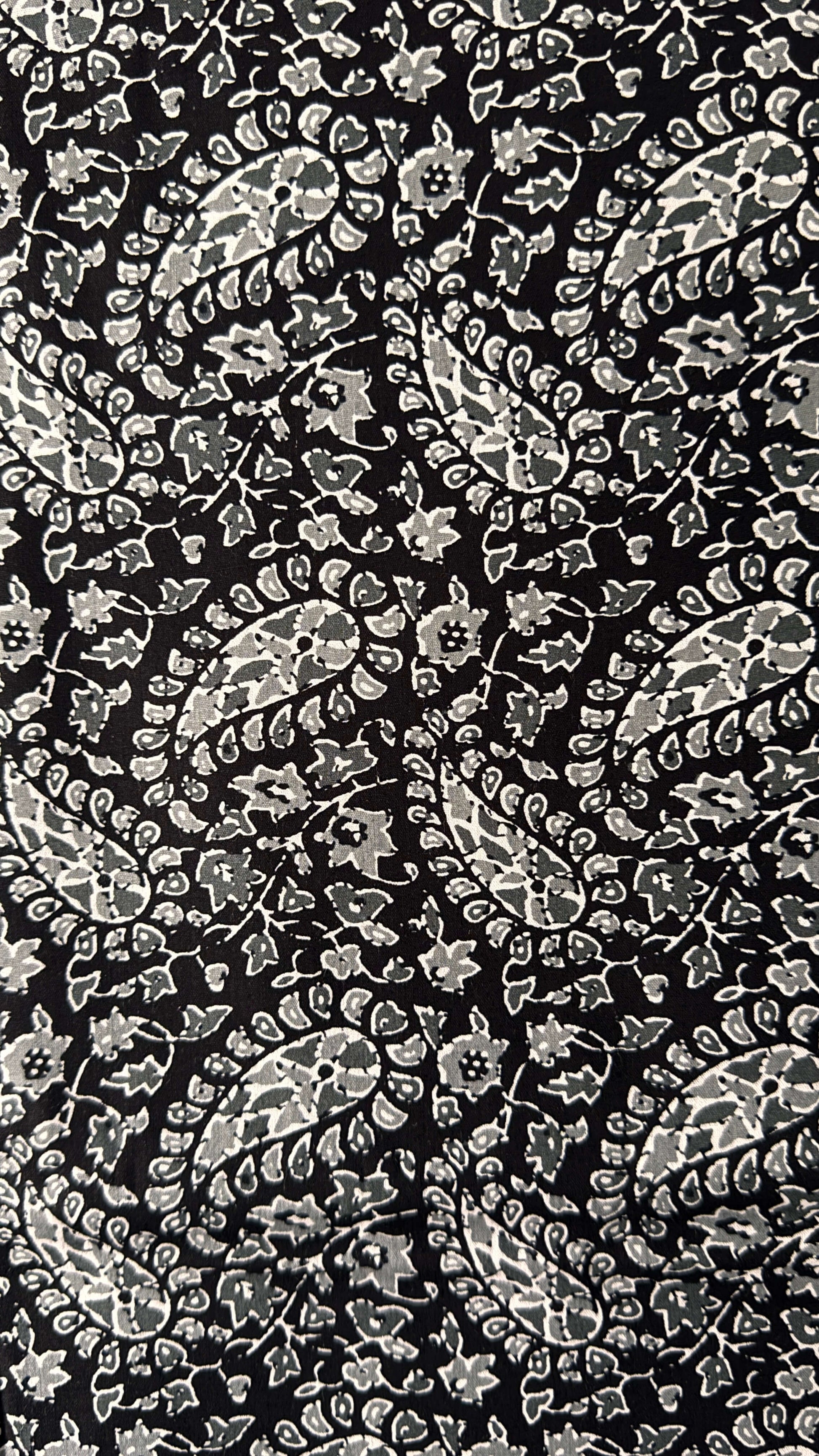 Black background with white floral pattern