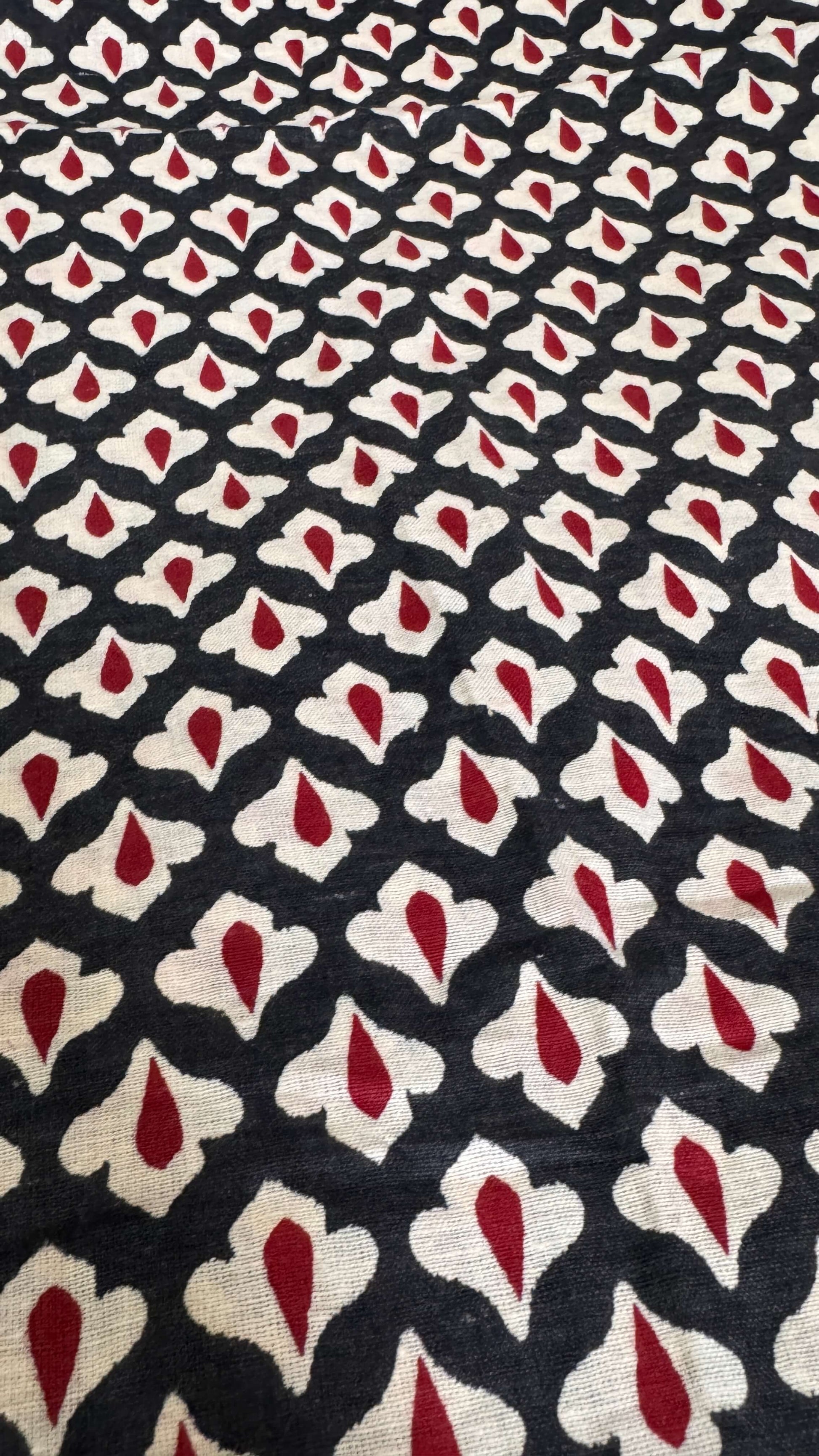 Patterned fabric with red, white, and black design