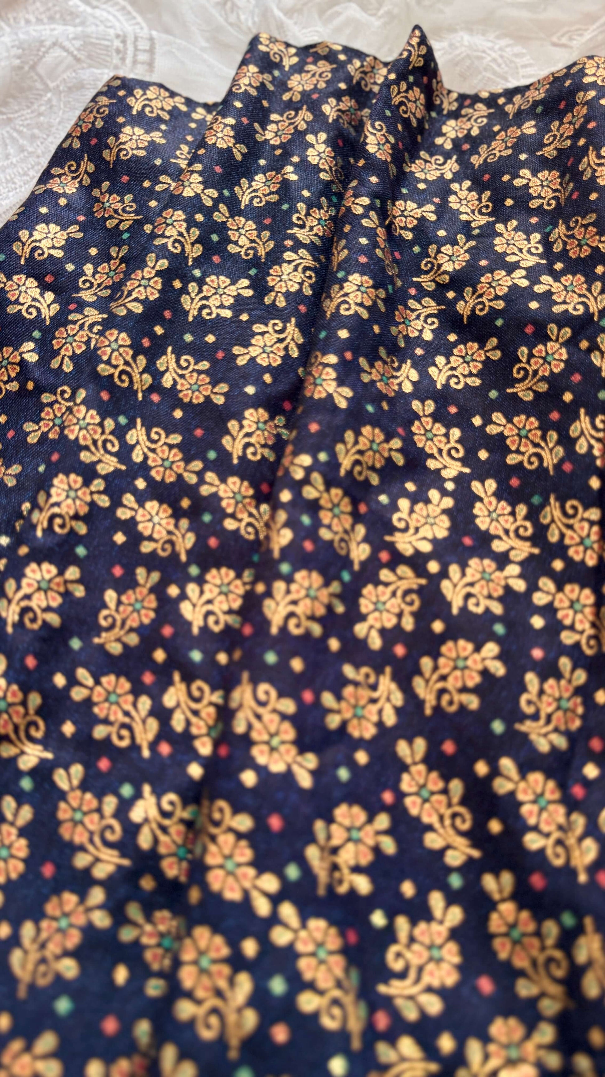 Navy blue fabric with gold floral pattern