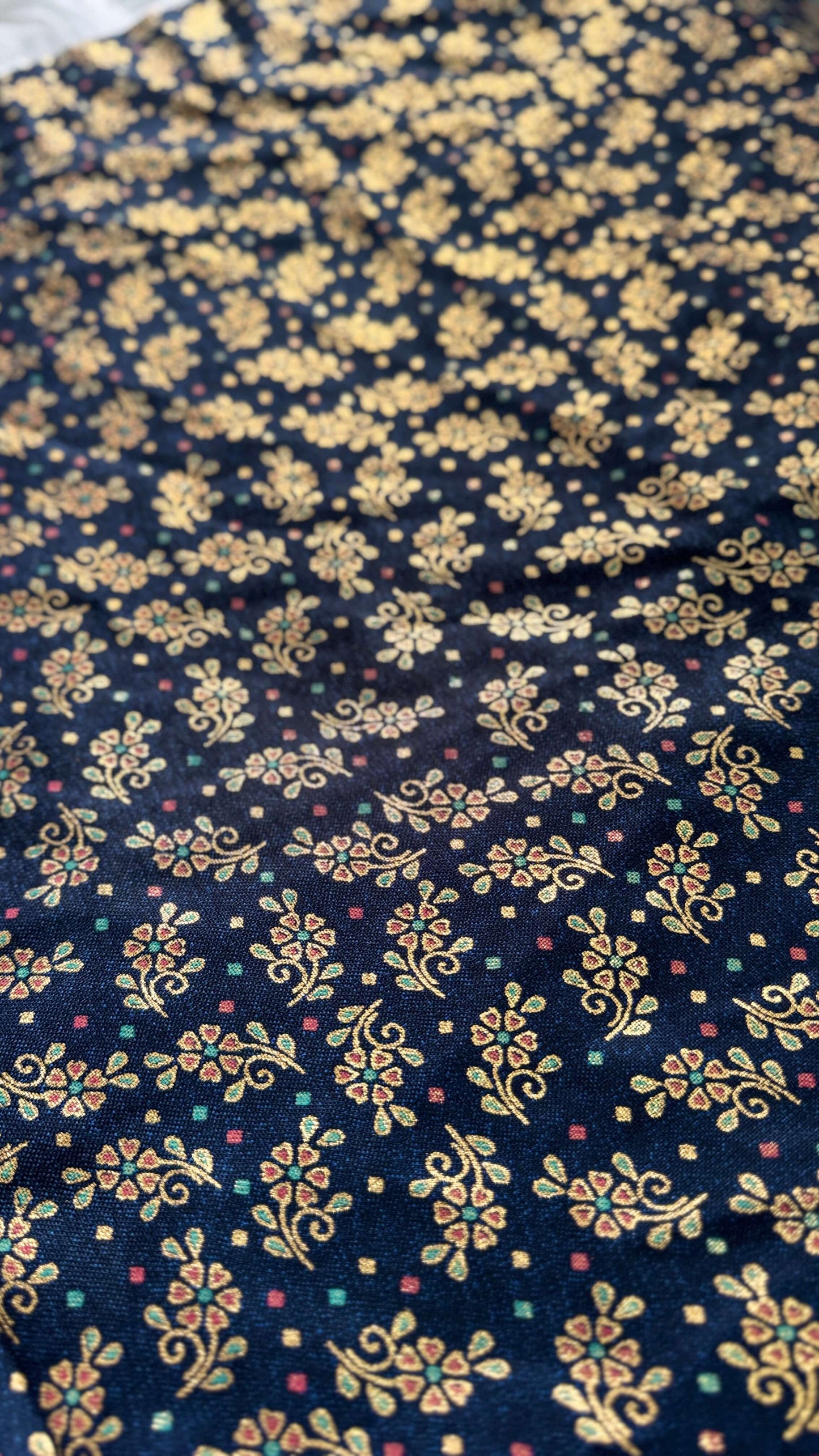 Navy blue fabric with gold floral pattern