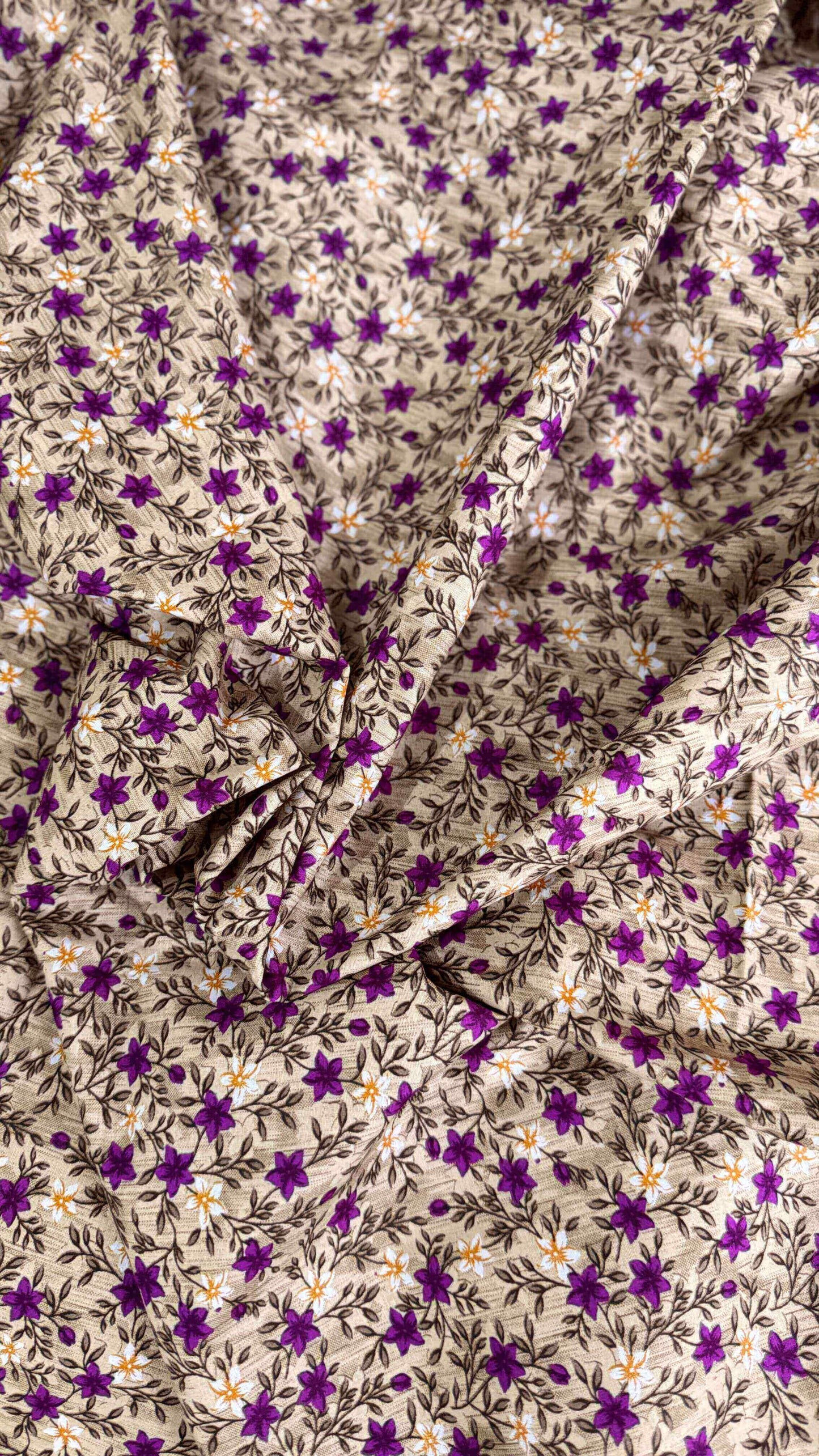 Floral fabric with purple flowers and white leaves on a beige background