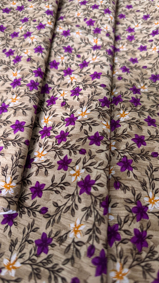 Close-up of fabric with purple floral pattern on beige background