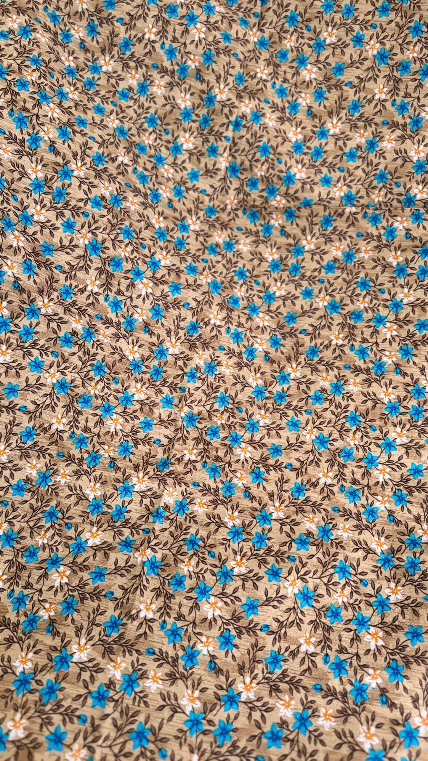 Floral pattern with blue flowers on a brown background