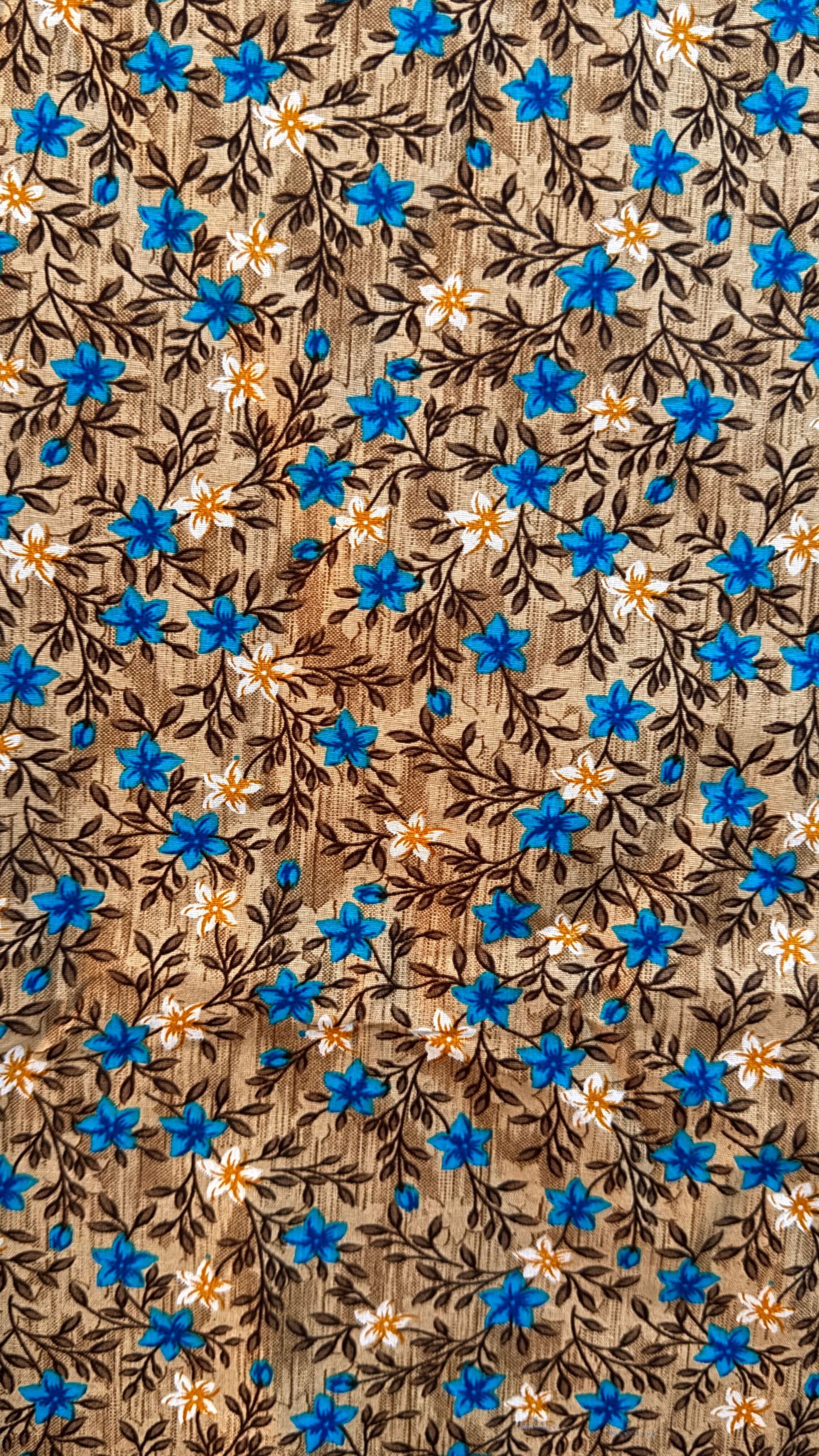 Floral pattern with blue flowers and brown leaves on a fabric background