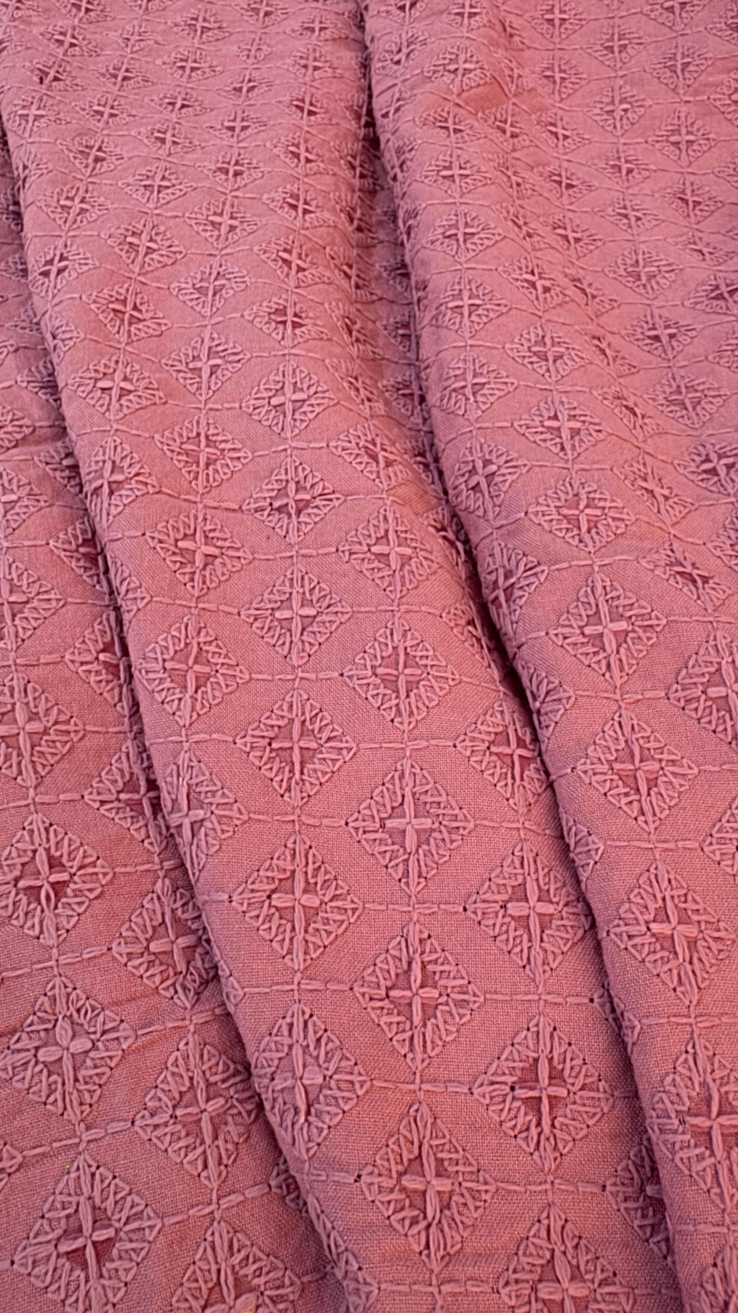 Close-up of pink textured fabric with geometric pattern