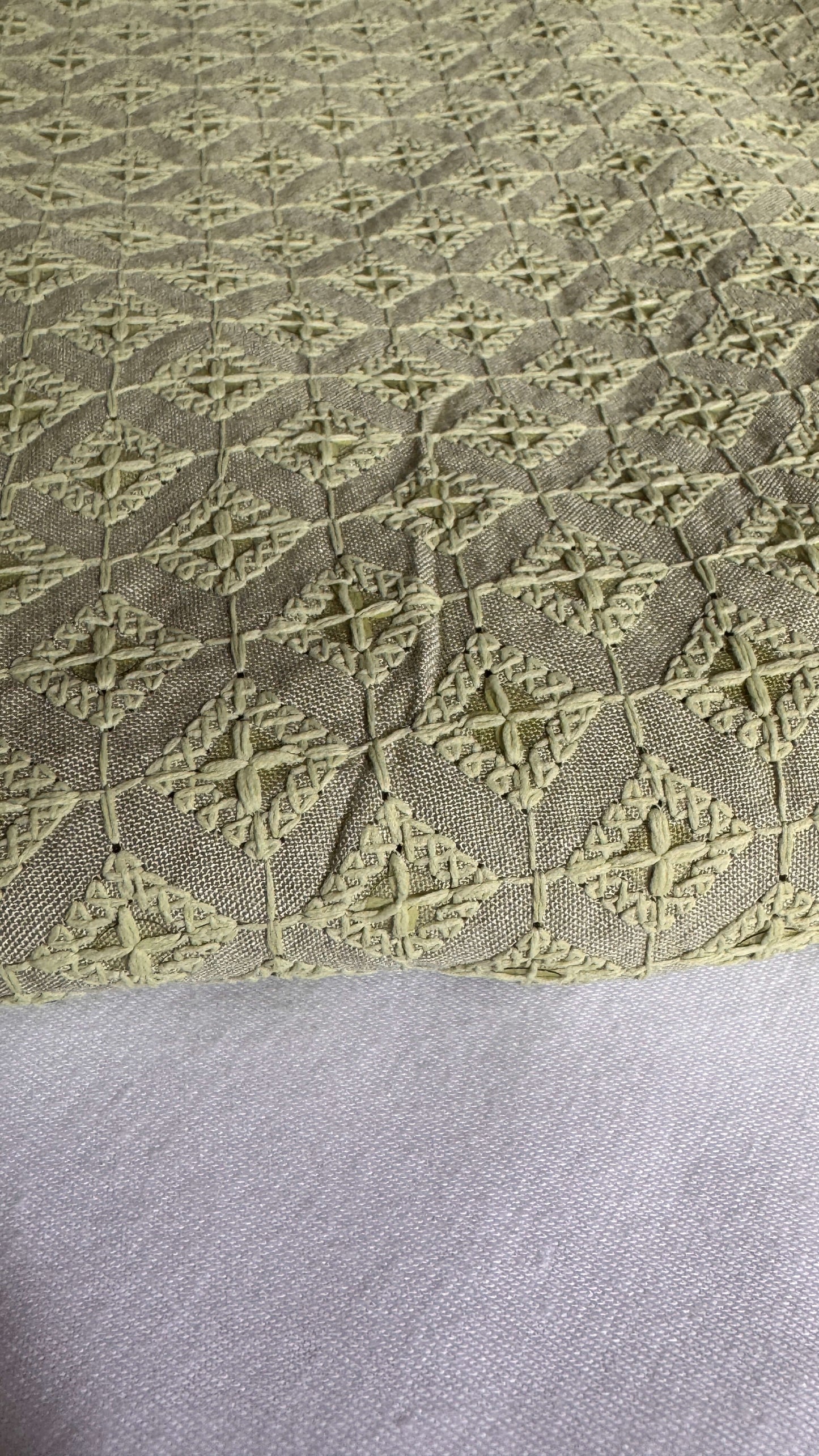 Textured fabric with geometric pattern on a gray background