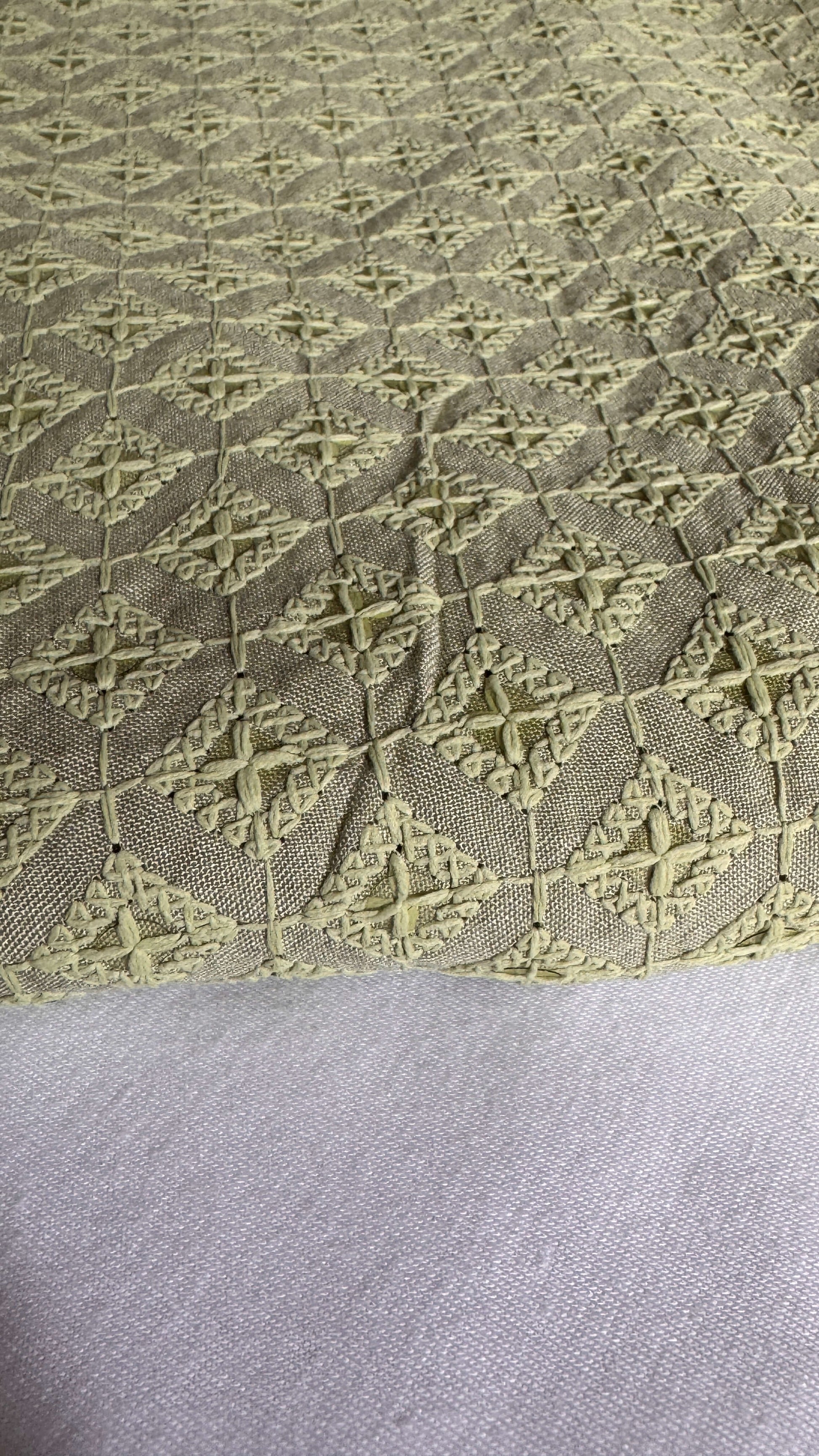 Textured fabric with geometric pattern on a gray background