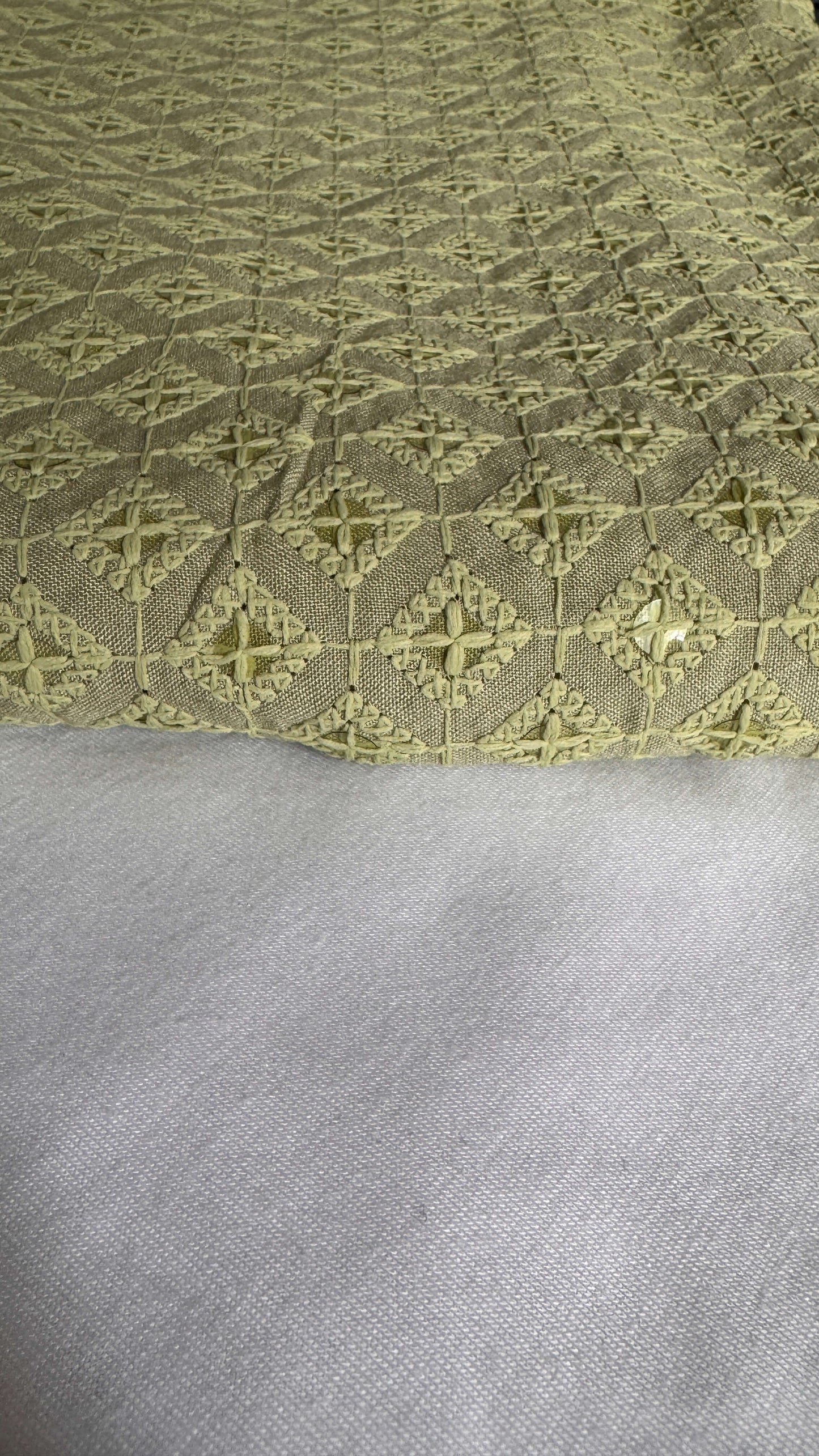 Close-up of a textured fabric with a geometric pattern on a gray background