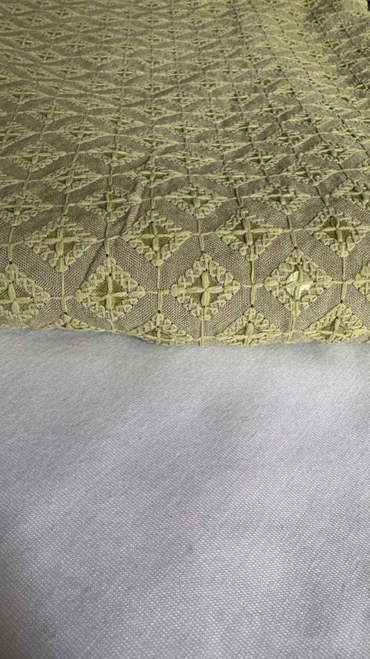 Close-up of a textured fabric with a geometric pattern on a gray background