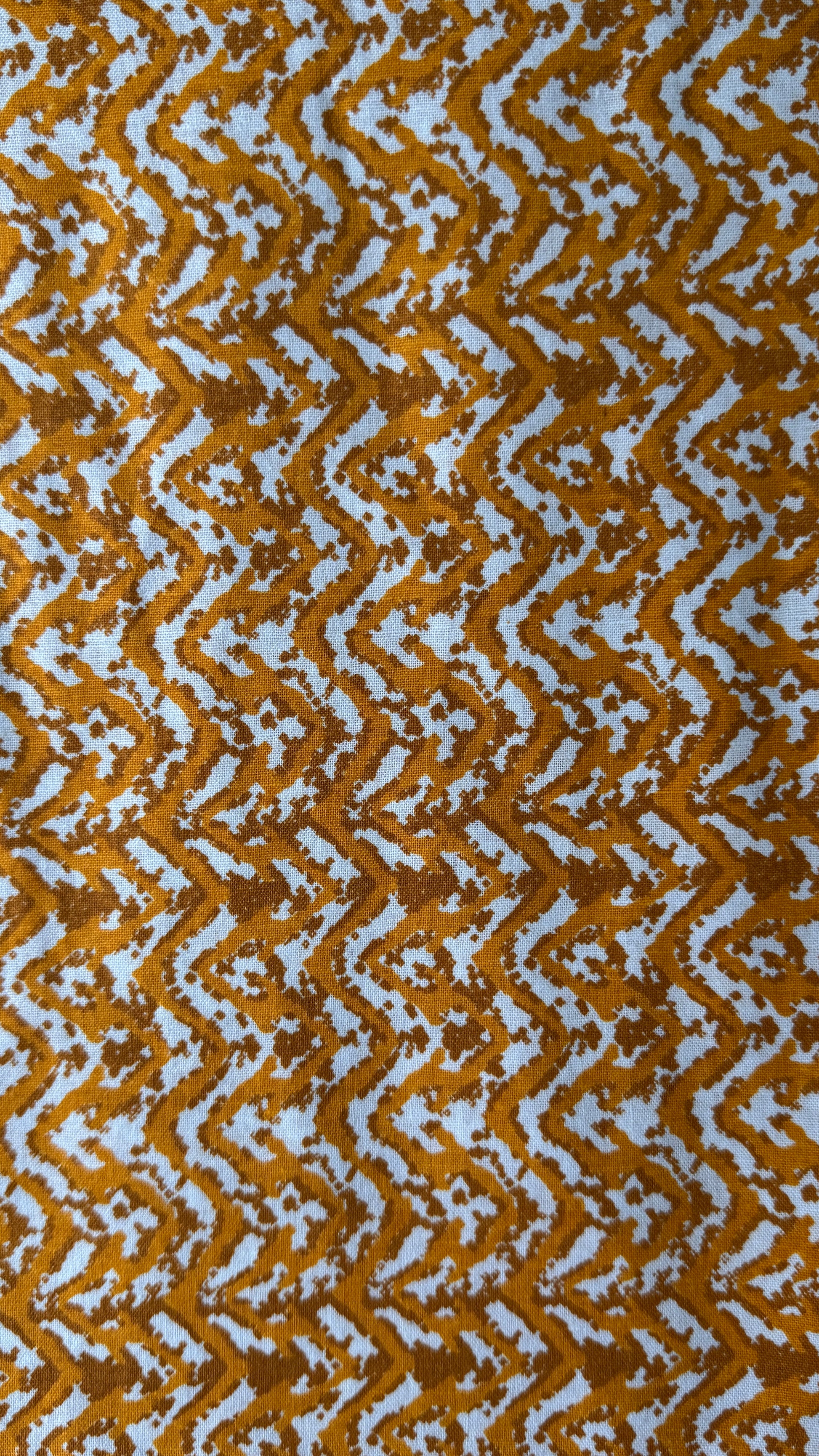 Patterned fabric with wavy brown and white design