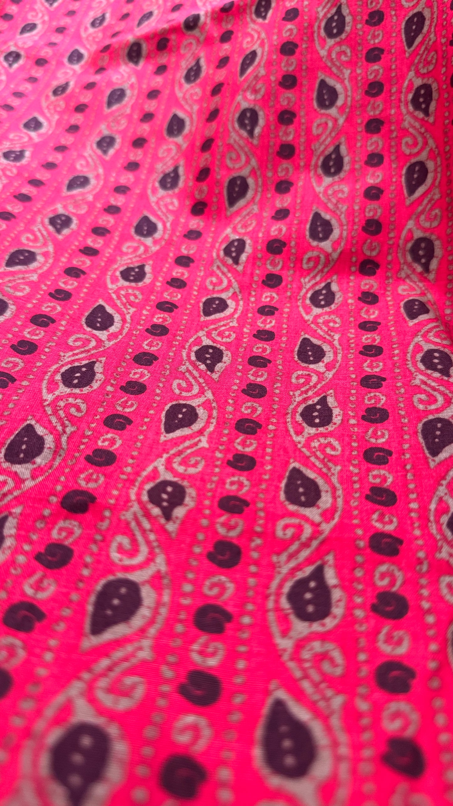 Pink fabric with black paisley pattern