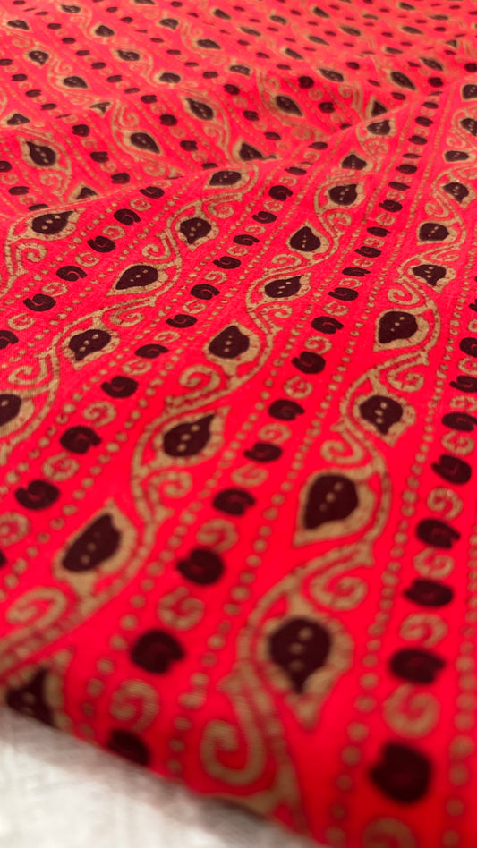 Red fabric with black paisley pattern