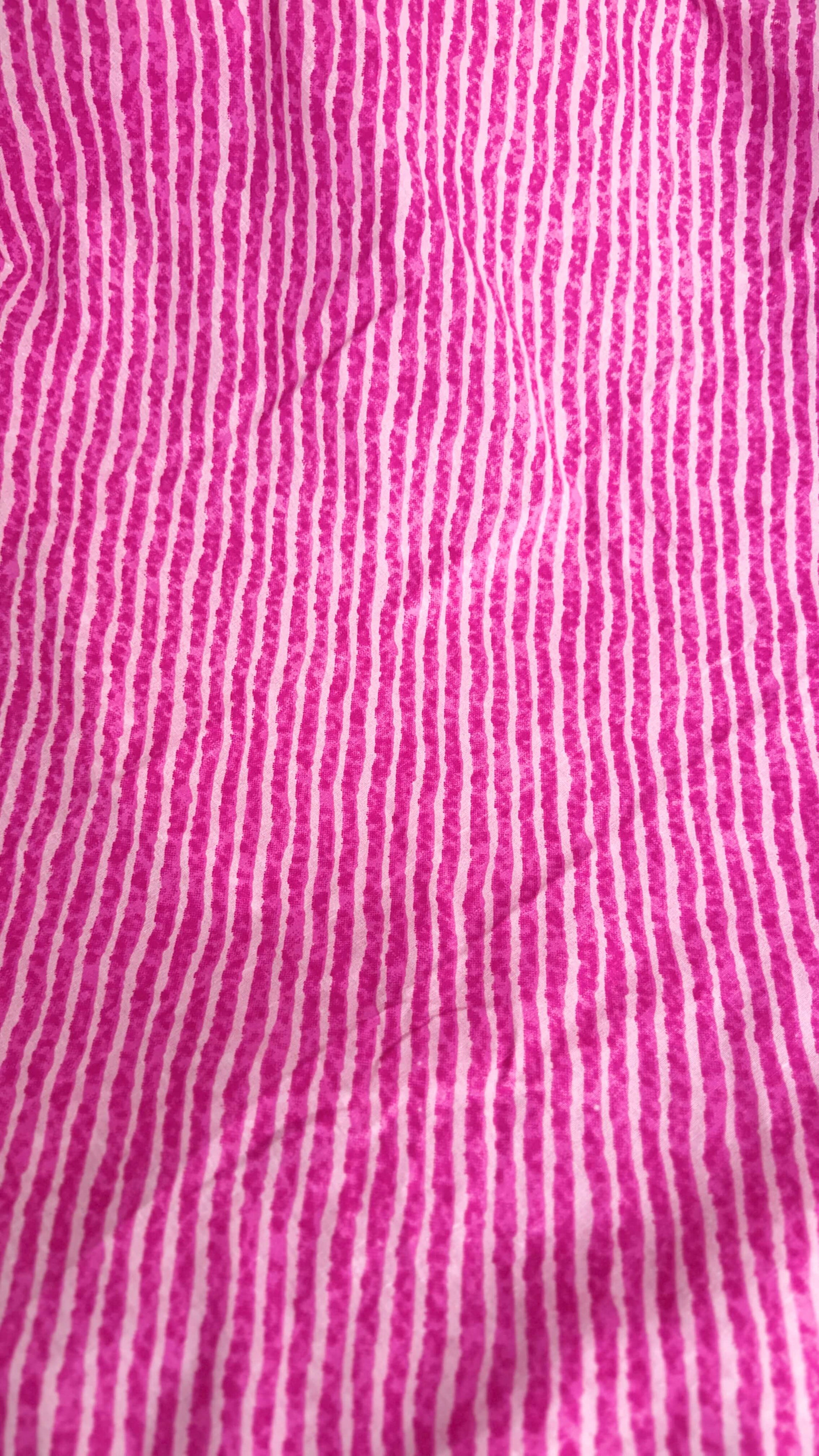 Close-up of pink fabric with white vertical stripes