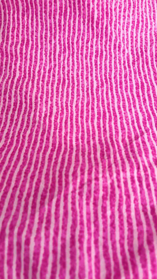 Close-up of pink fabric with white vertical stripes