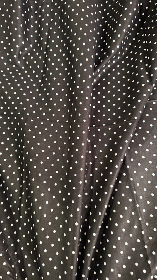 Close-up of black fabric with white polka dots