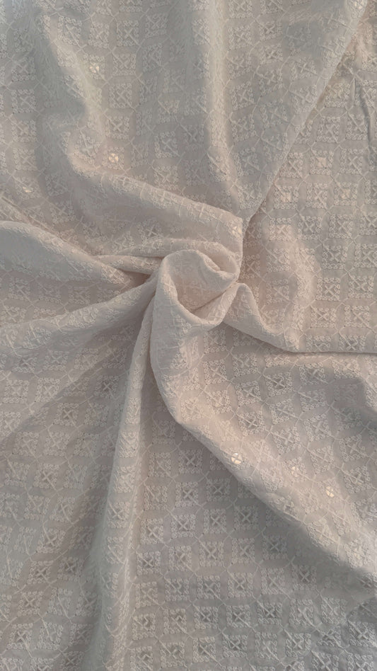 Close-up of textured beige fabric with subtle pattern