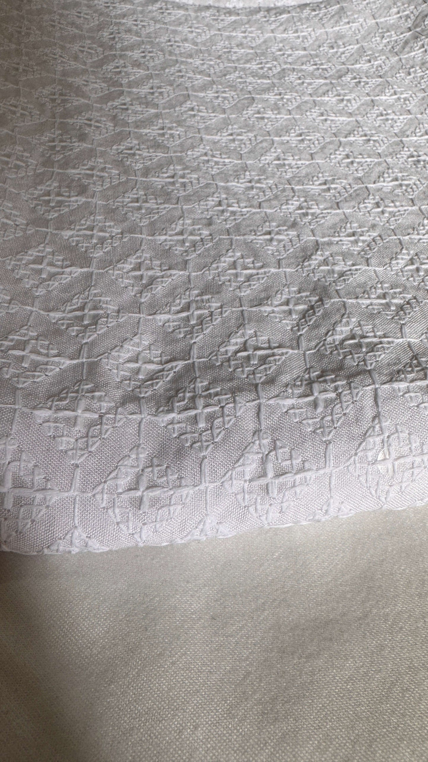 Textured white fabric with a subtle pattern