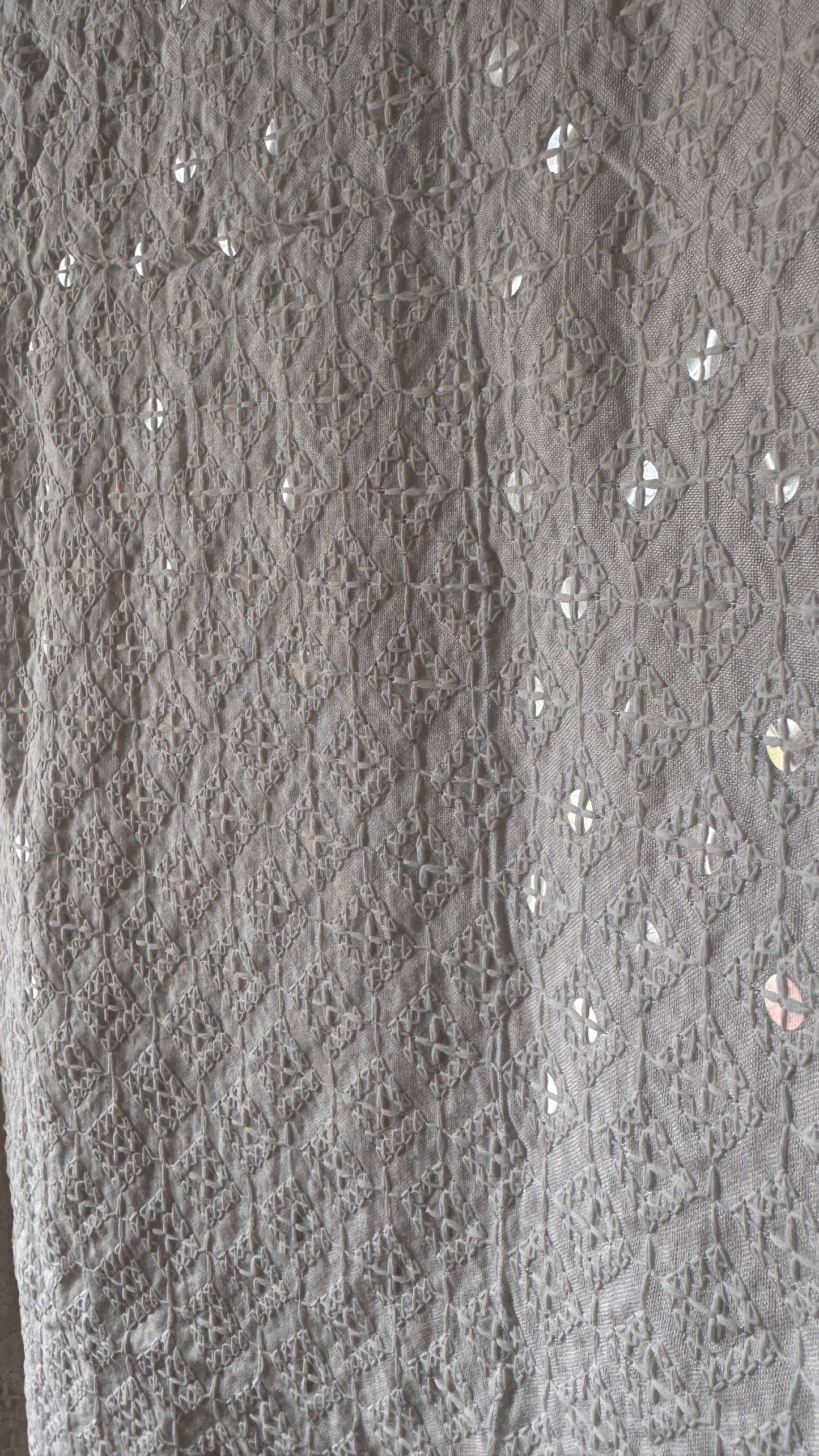 Close-up of textured gray fabric with floral patterns