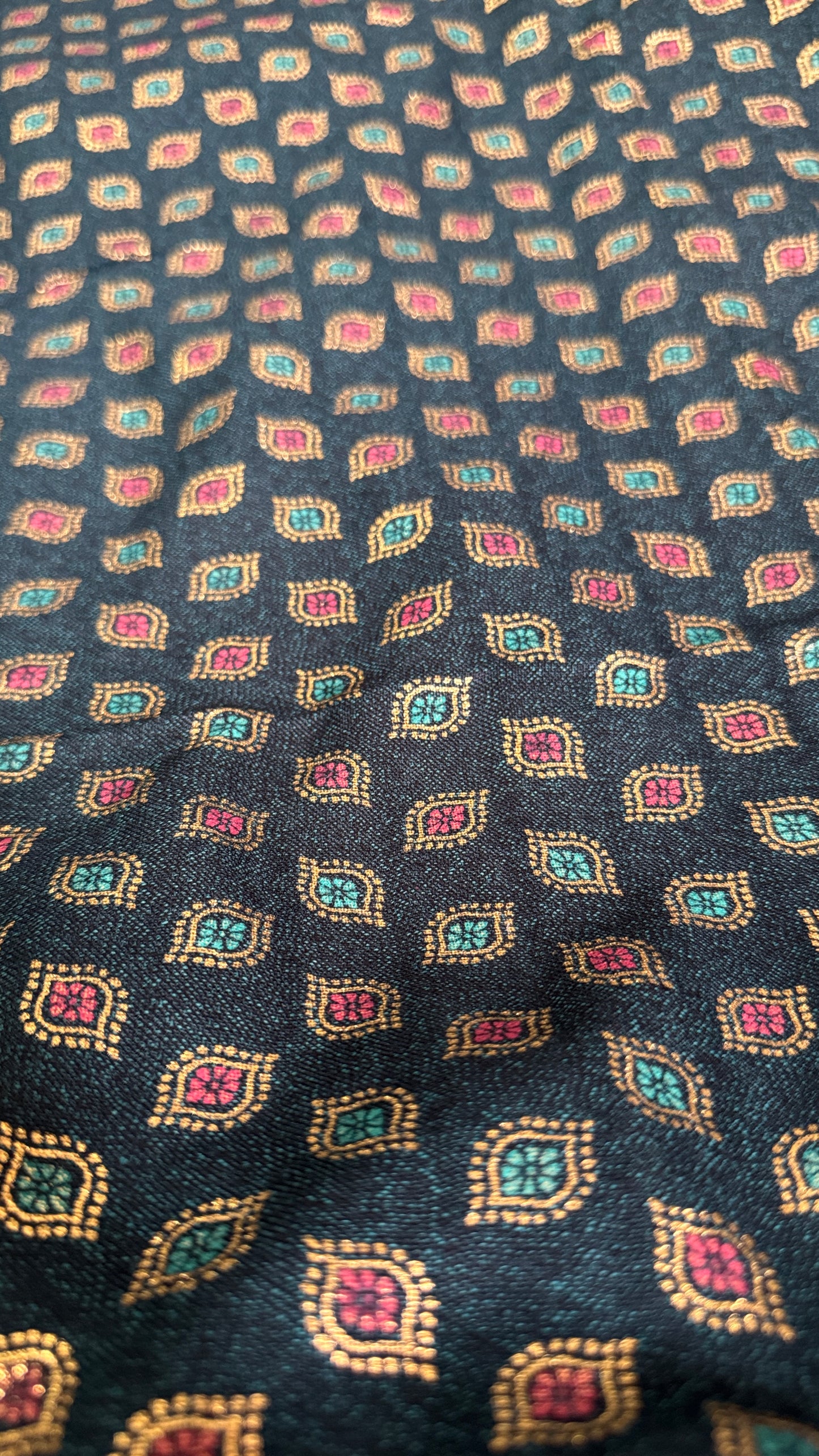 Patterned fabric with small geometric designs on a dark background