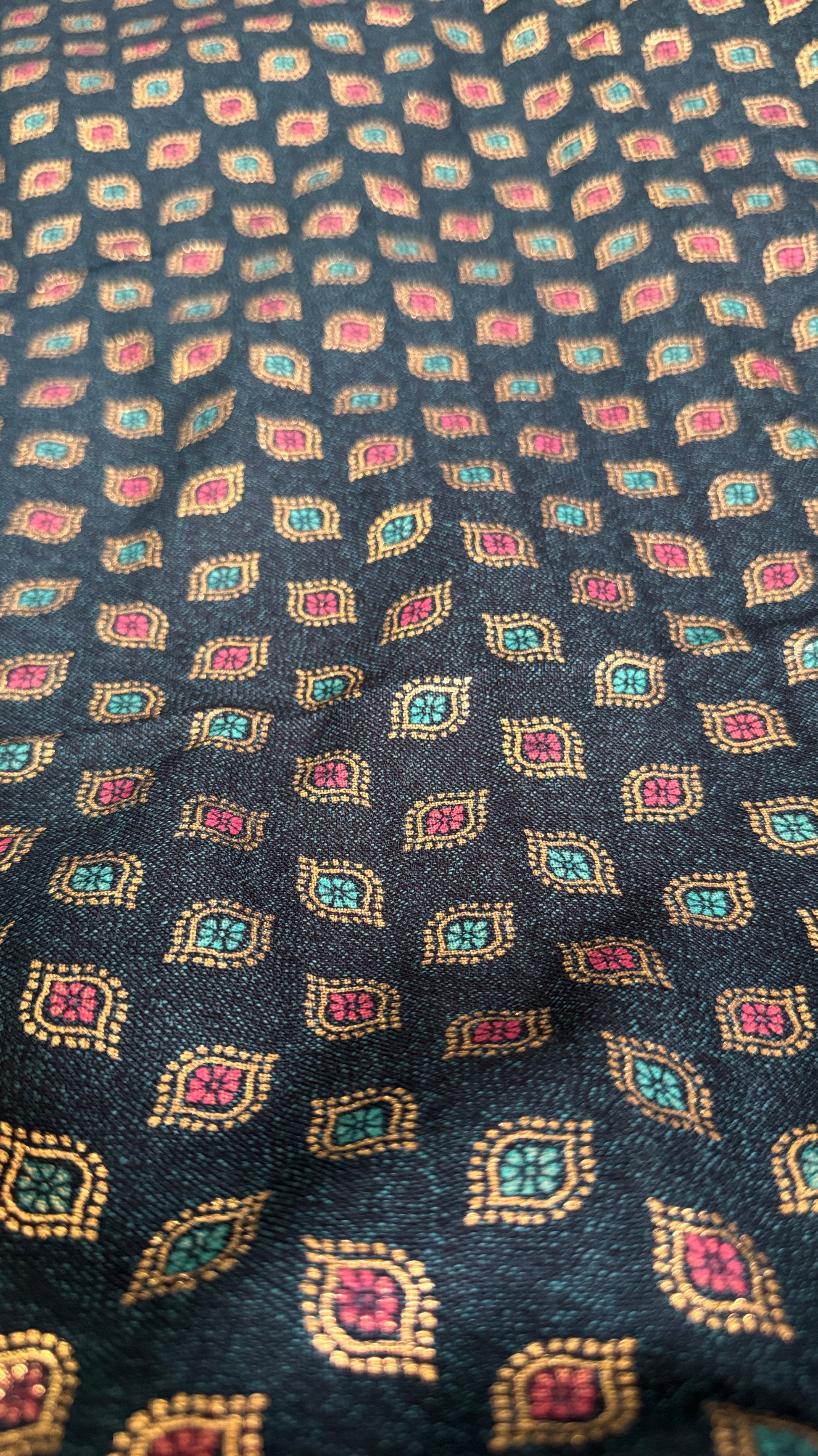 Patterned fabric with small geometric designs on a dark background