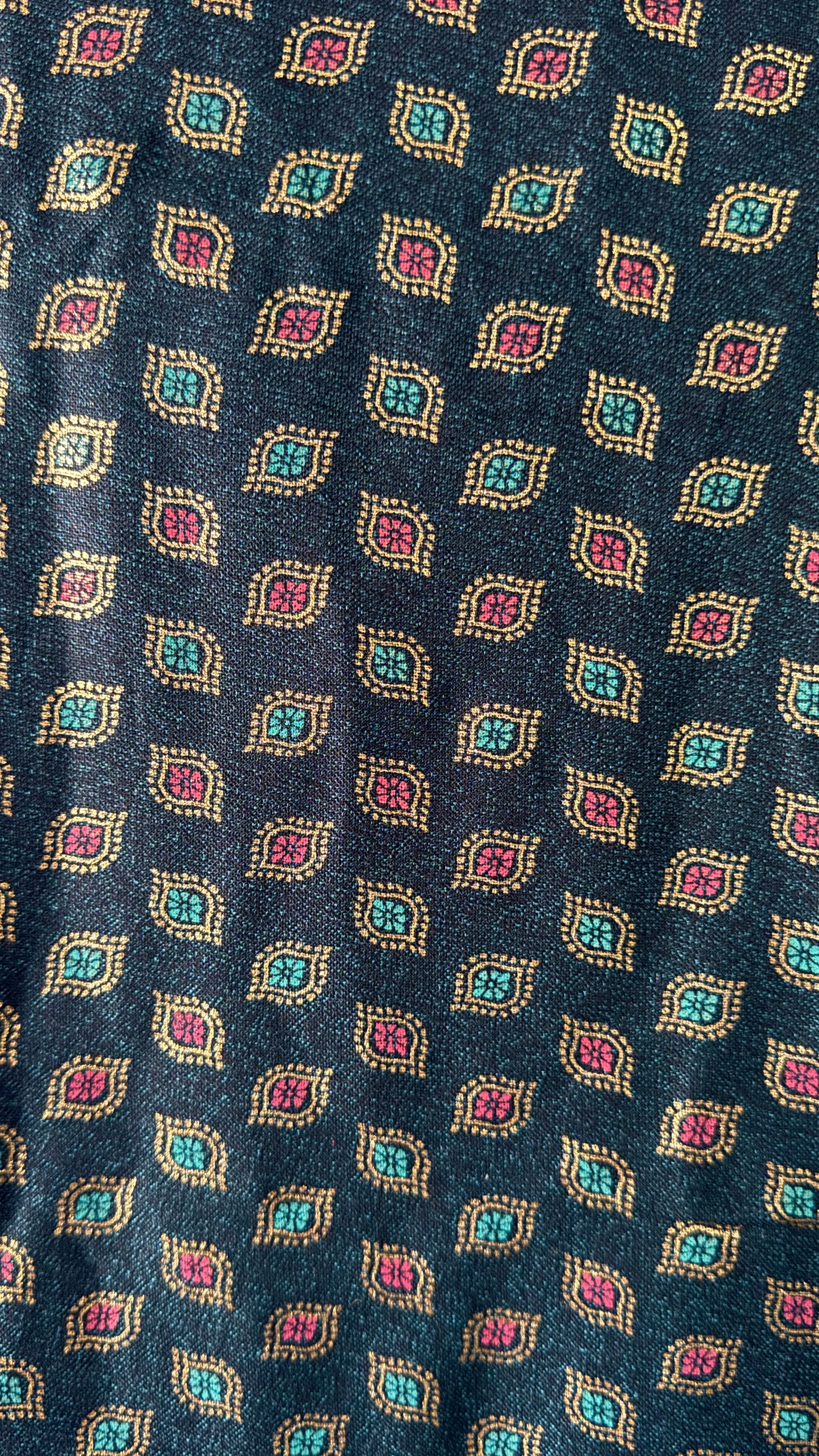 Close-up of a patterned fabric with geometric design on a dark blue background