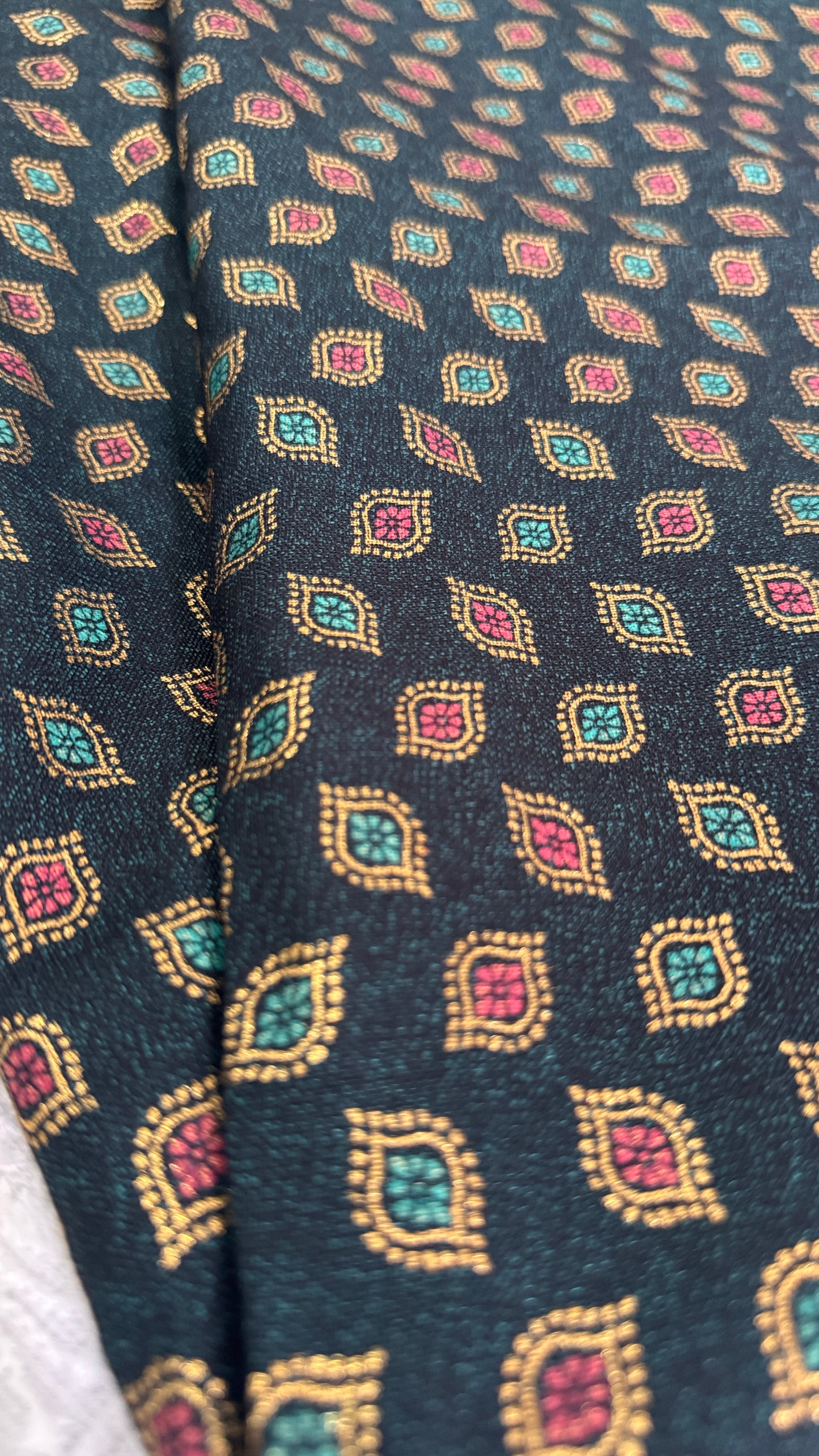 Close-up of patterned fabric with geometric design on a dark background