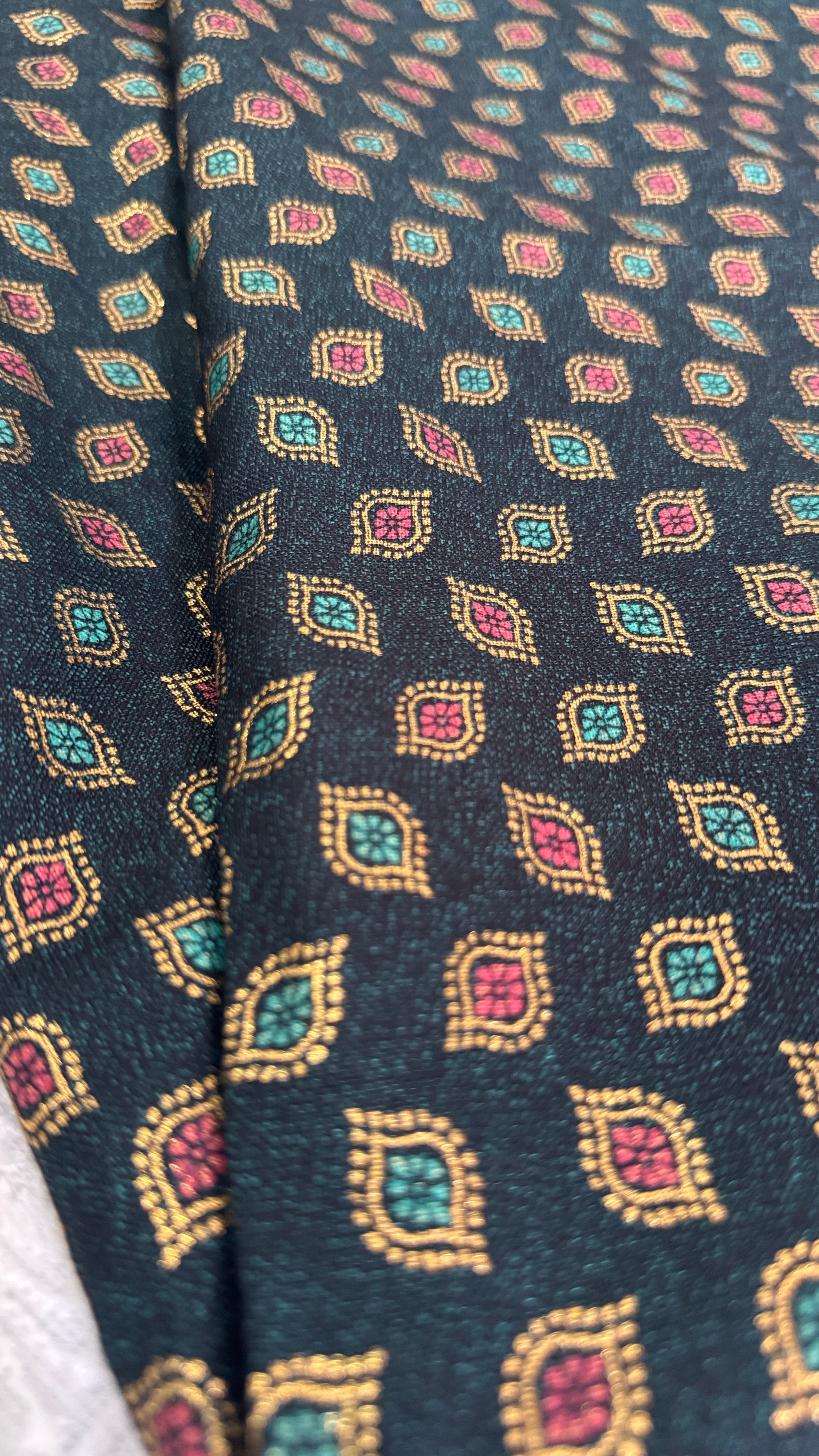 Close-up of patterned fabric with geometric design on a dark background