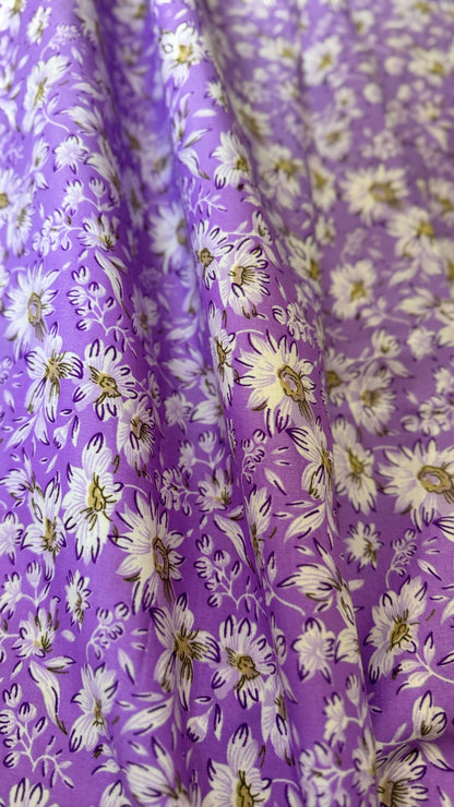 Floral fabric with white flowers on a purple background