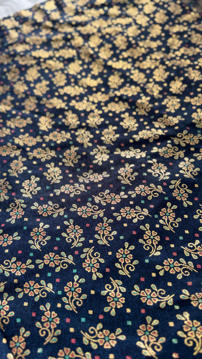 Navy blue fabric with gold floral pattern