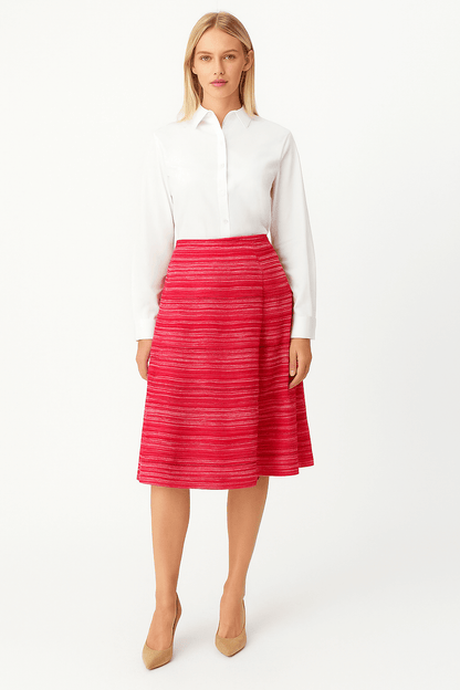 Woman wearing a white blouse and red striped skirt on a white background