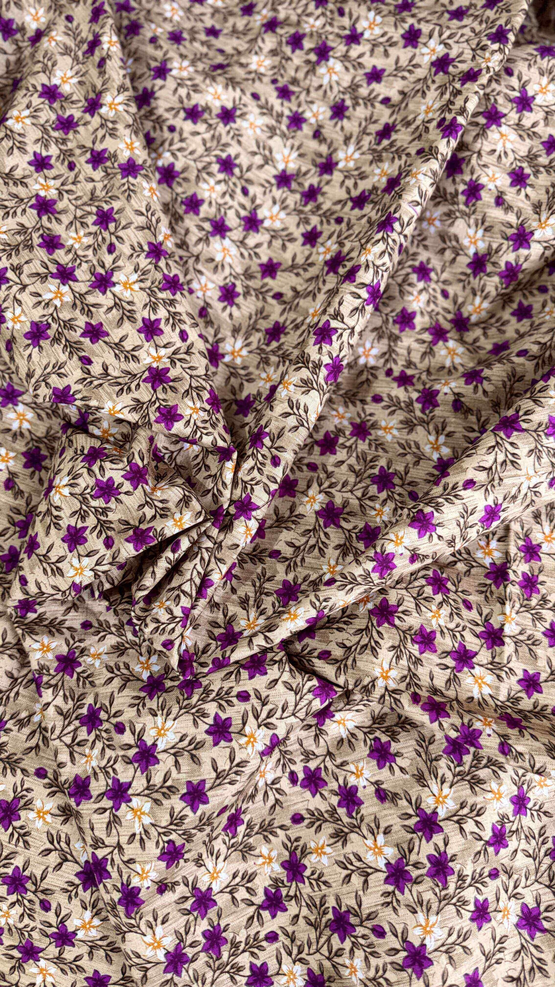 Floral fabric with purple flowers and white leaves on a beige background