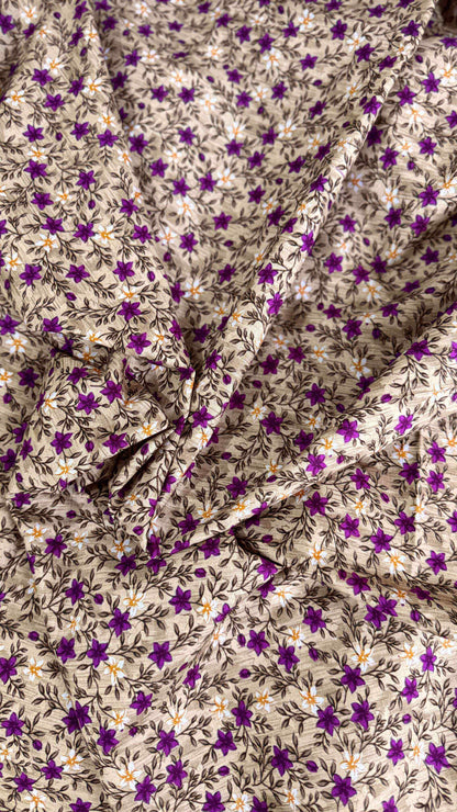 Floral fabric with purple flowers and white leaves on a beige background