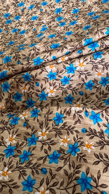 Floral fabric pattern with blue flowers on a brown background