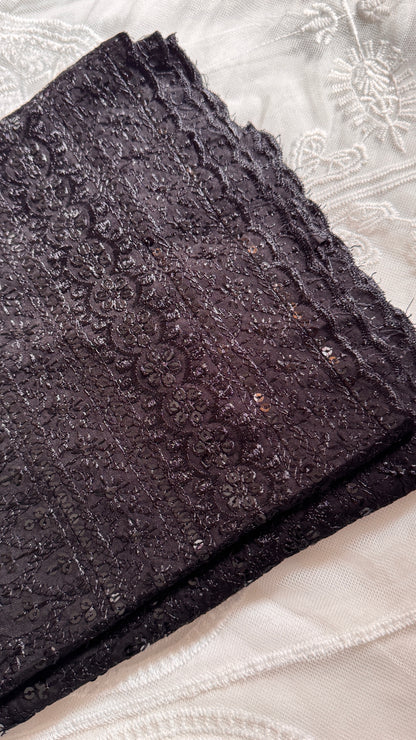 Dark textured fabric on a light background