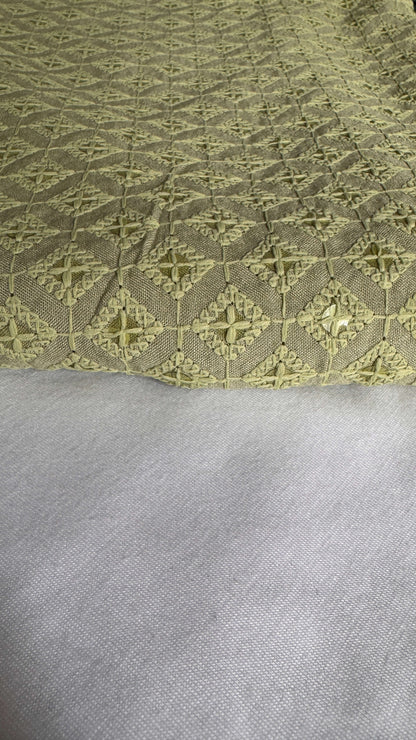Close-up of a textured fabric with a geometric pattern on a gray background