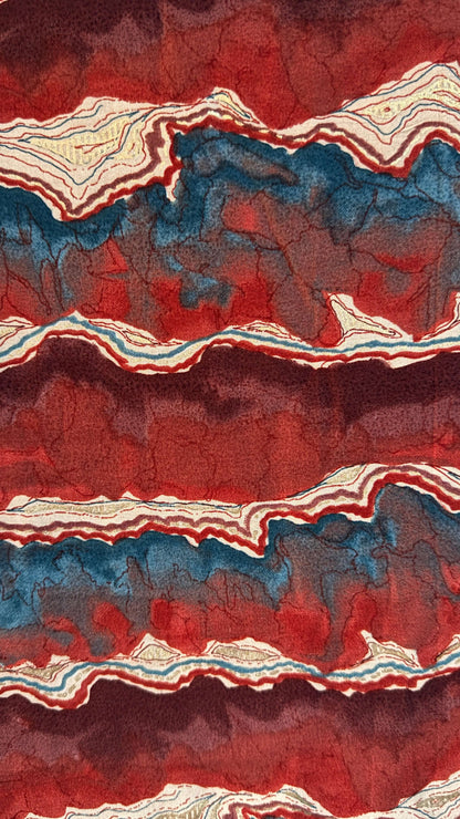 Artistic depiction of layered rock or mineral formation with red, blue, and white colors.