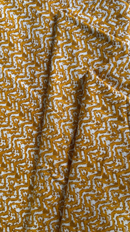Close-up of fabric with a yellow and white geometric pattern