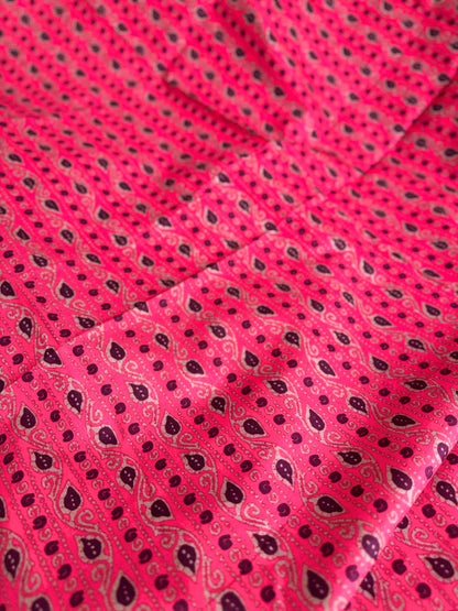 Close-up of pink fabric with black paisley pattern