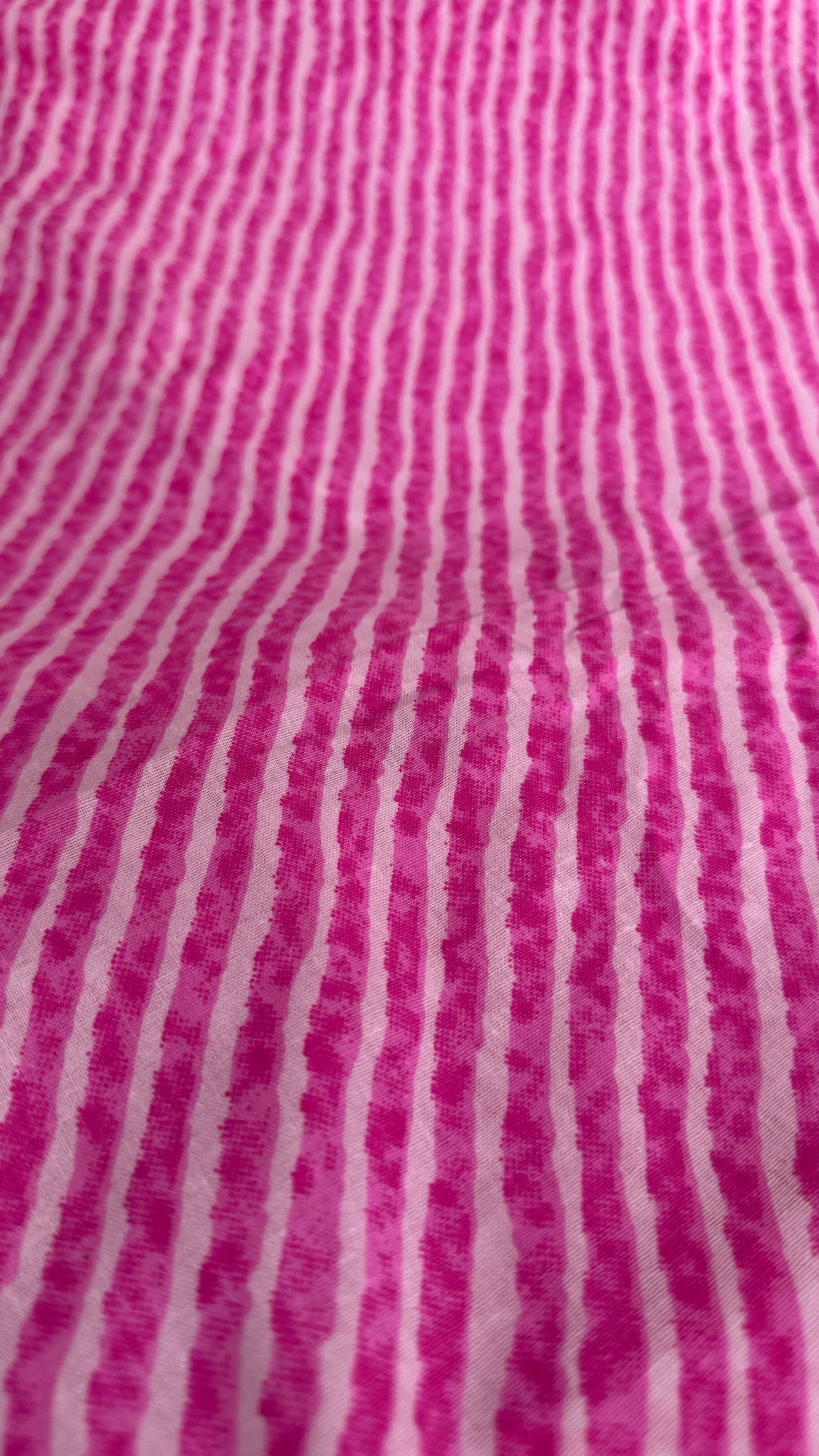 Close-up of pink fabric with white stripes