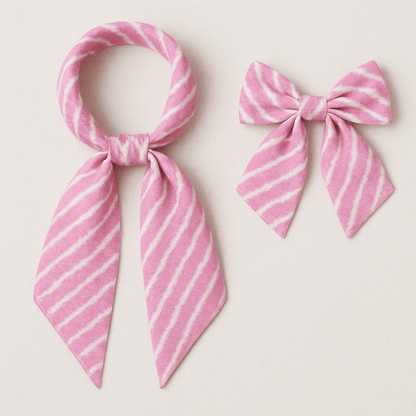 Pink and white striped scarf and bow on a light background