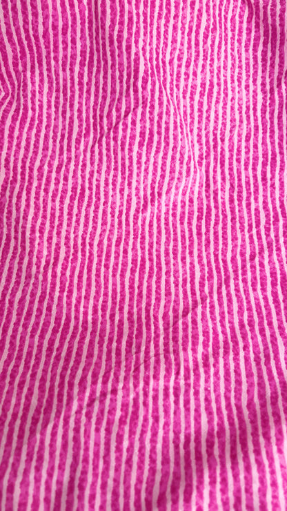 Close-up of pink fabric with white vertical stripes