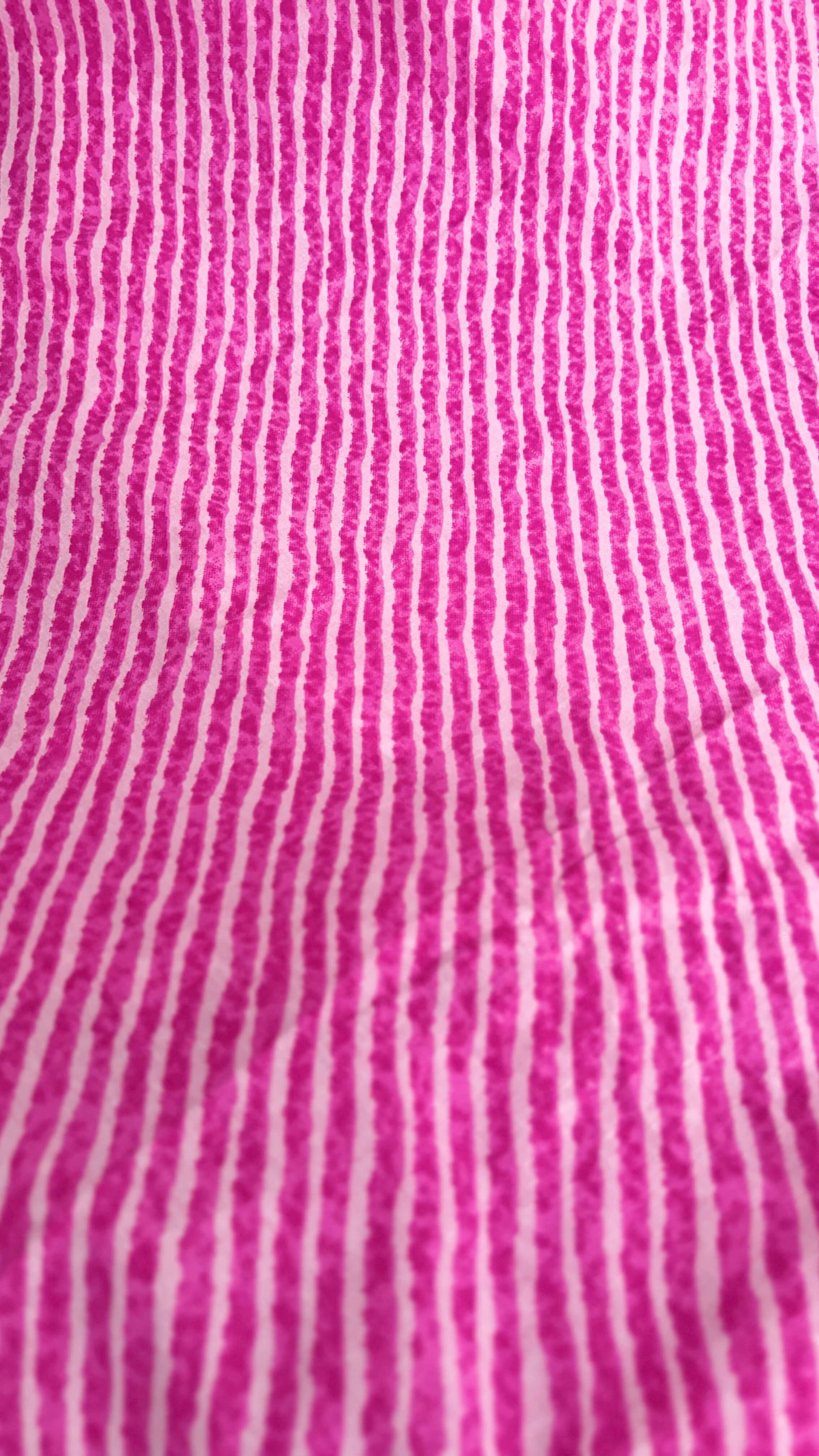 Close-up of pink fabric with white vertical stripes
