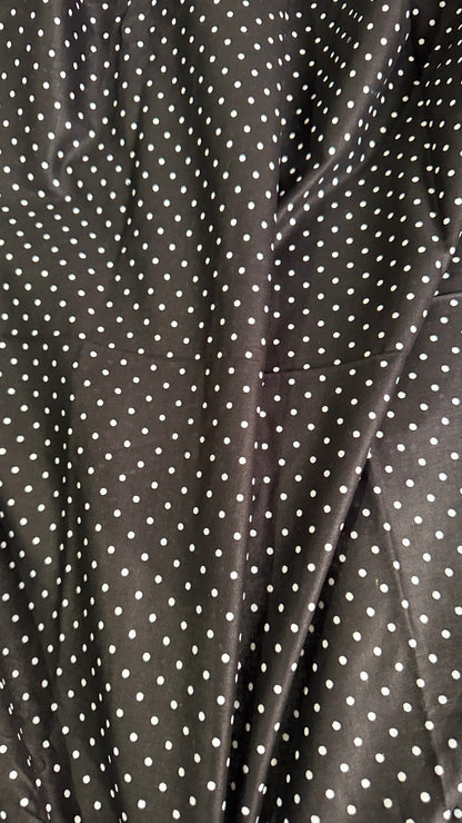 Close-up of black fabric with white polka dots
