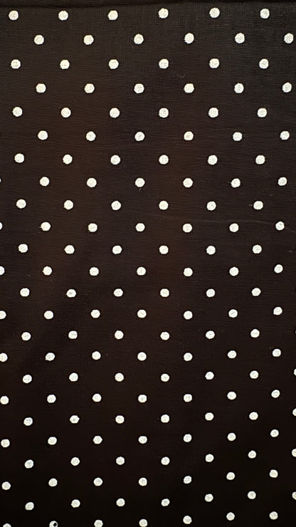 Black fabric with white polka dots