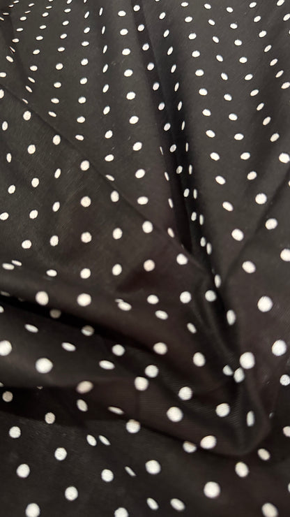 Black fabric with white polka dots