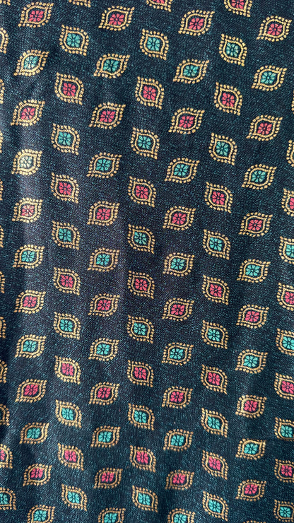 Close-up of a patterned fabric with geometric design on a dark blue background